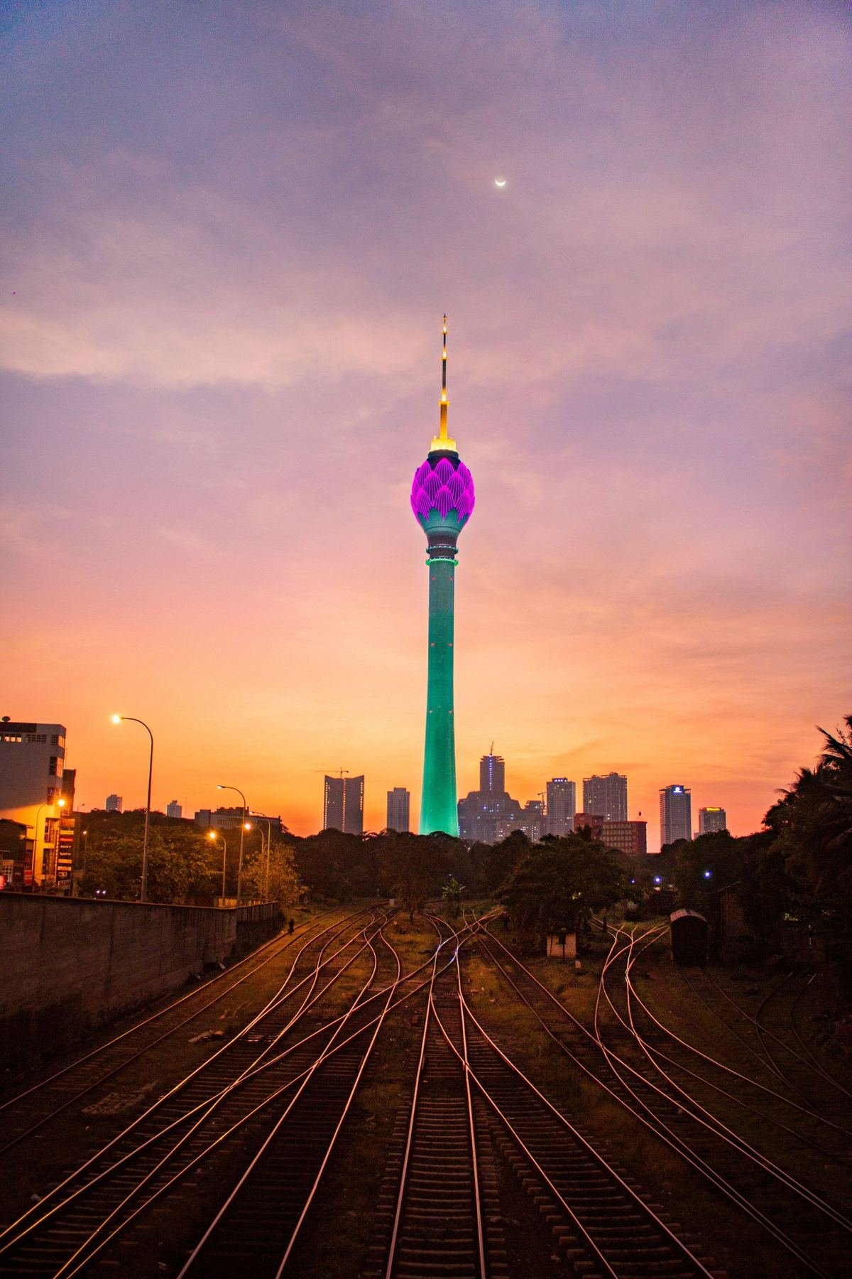 The Lotus Tower in Colombo at dusk, above the city skyline and railway lines